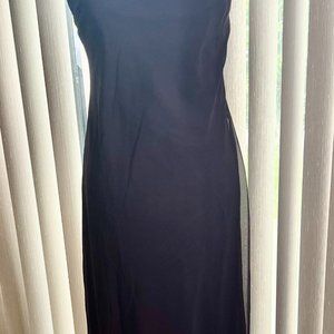 Long evening dress with flowing back layer.